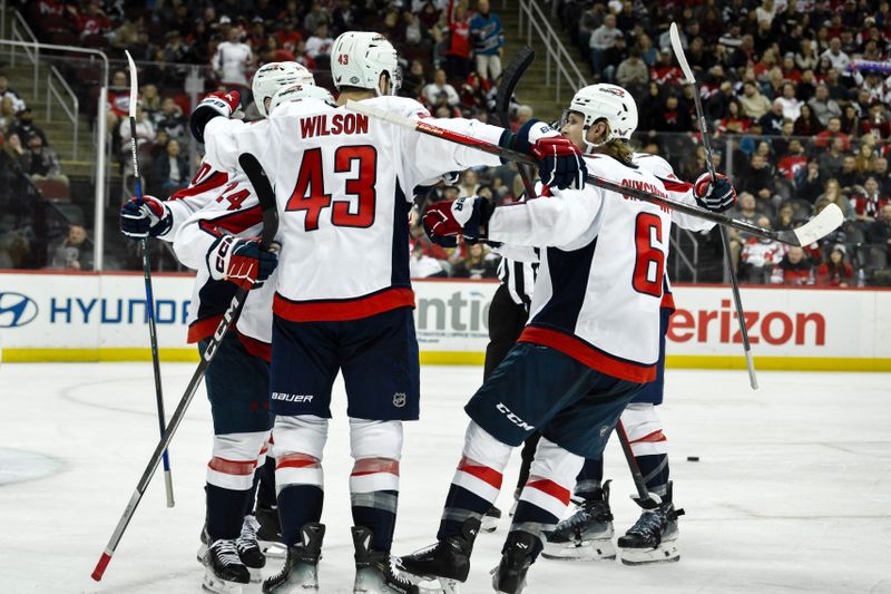 Oct 19, 2024; Newark, New Jersey, USA; Washington Capitals center Connor McMichael (24) celebrates with teammates after scoring a goal against the New Jersey Devils during the first period at Prudential Center. Mandatory Credit: John Jones-Imagn Images