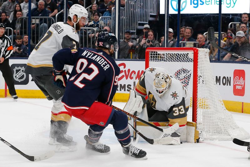 Mar 4, 2024; Columbus, Ohio, USA; Vegas Golden Knights goalie Adin Hill (33) makes a save against the Columbus Blue Jackets during the second period at Nationwide Arena. Mandatory Credit: Russell LaBounty-USA TODAY Sports