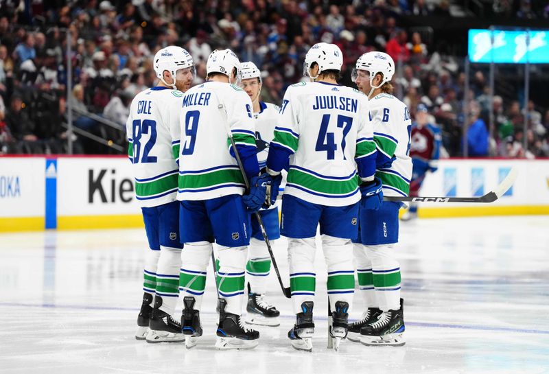 Nov 22, 2023; Denver, Colorado, USA; Members of the Vancouver Canucks huddle in the second period against the Colorado Avalanche at Ball Arena. Mandatory Credit: Ron Chenoy-USA TODAY Sports