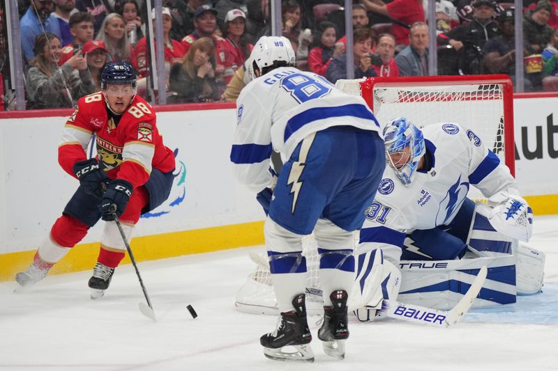 Sep 30, 2024; Sunrise, Florida, USA; Tampa Bay Lightning goaltender Jonas Johansson (31) keeps an eye on the puck as Florida Panthers defenseman Nate Schmidt (88) closes in during the second period at Amerant Bank Arena. Mandatory Credit: Jim Rassol-Imagn Images