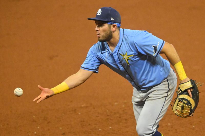 Sep 13, 2024; Cleveland, Ohio, USA; Tampa Bay Rays first baseman Jonathan Aranda (62) tosses the ball to first base in the sixth inning Cleveland Guardians at Progressive Field. Mandatory Credit: David Richard-Imagn Images