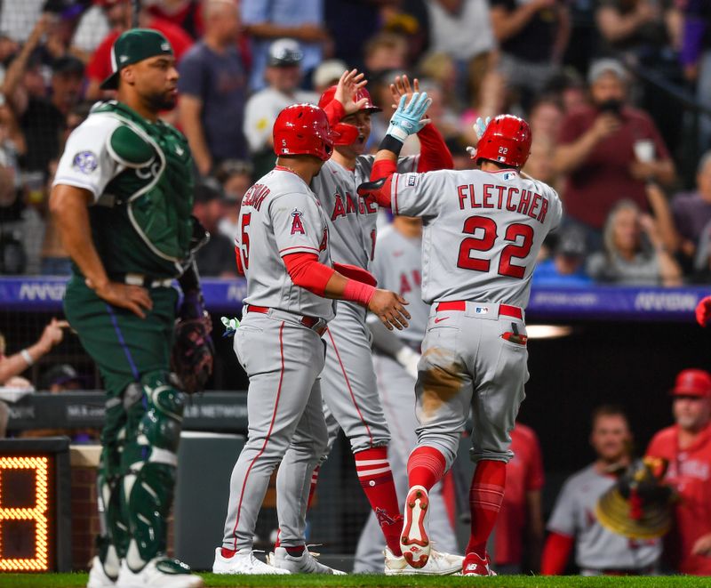 Jun 24, 2023; Denver, Colorado, USA; Los Angeles Angels shortstop David Fletcher (22) gets high fives from Los Angeles Angels third baseman Eduardo Escobar (5) and Los Angeles Angels right fielder Mickey Moniak (16) after his home run in the fourth inning against the Colorado Rockies at Coors Field. Mandatory Credit: John Leyba-USA TODAY Sports