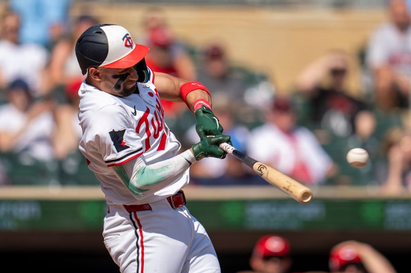 Sep 15, 2024; Minneapolis, Minnesota, USA; Minnesota Twins third baseman Royce Lewis (23) hits a single against the Cincinnati Reds in the fourth inning at Target Field. Mandatory Credit: Jesse Johnson-Imagn Images