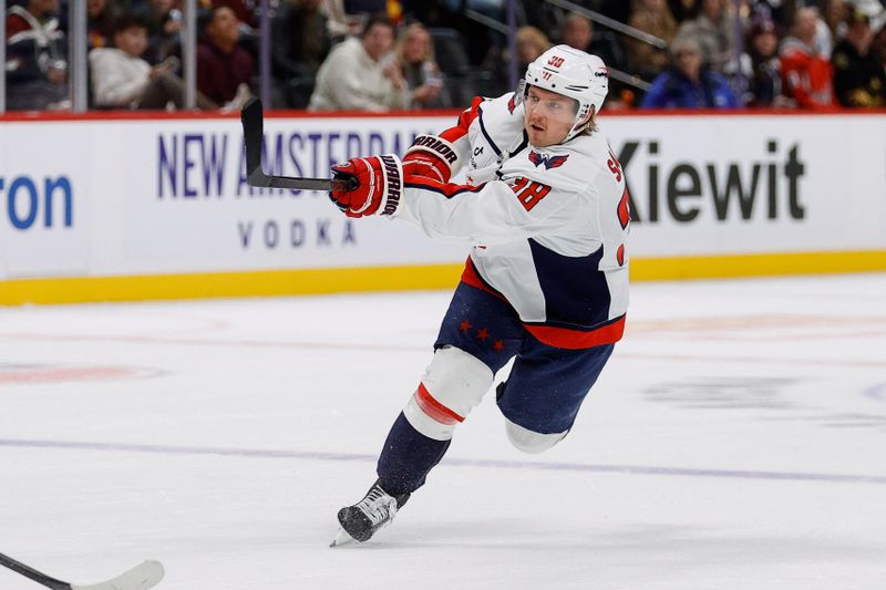 Nov 15, 2024; Denver, Colorado, USA; Washington Capitals defenseman Rasmus Sandin (38) scores on an empty net shot in the third period against the Colorado Avalanche at Ball Arena. Mandatory Credit: Isaiah J. Downing-Imagn Images