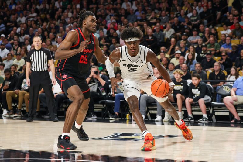 Jan 25, 2023; Orlando, Florida, USA; UCF Knights forward Taylor Hendricks (25) drives to the basket against Houston Cougars forward Jarace Walker (25) during the first half at Addition Financial Arena. Mandatory Credit: Mike Watters-USA TODAY Sports