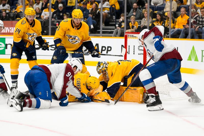 Nov 2, 2024; Nashville, Tennessee, USA;  Nashville Predators goaltender Juuse Saros (74) and defenseman Alexandre Carrier (45) blocks the shot of Colorado Avalanche right wing Mikko Rantanen (96) during the second period at Bridgestone Arena. Mandatory Credit: Steve Roberts-Imagn Images