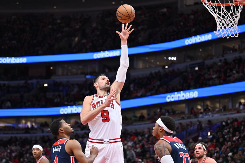 CHICAGO, ILLINOIS - MARCH 16:  Nikola Vucevic #9 of the Chicago Bulls shoots over Richaun Holmes #22 of the Washington Wizards in the second half on March 16, 2024 at United Center in Chicago, Illinois. Chicago defeated Washington 127-98.   NOTE TO USER: User expressly acknowledges and agrees that, by downloading and or using this photograph, User is consenting to the terms and conditions of the Getty Images License Agreement.  (Photo by Jamie Sabau/Getty Images)