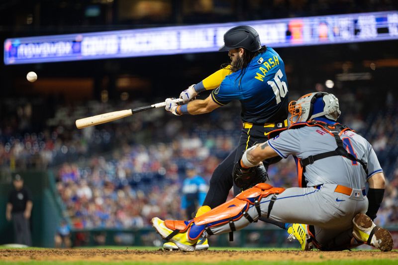 Sep 13, 2024; Philadelphia, Pennsylvania, USA; Philadelphia Phillies outfielder Brandon Marsh (16) hits a three run home run in front of New York Mets catcher Francisco Alvarez (4) during the ninth inning at Citizens Bank Park. Mandatory Credit: Bill Streicher-Imagn Images