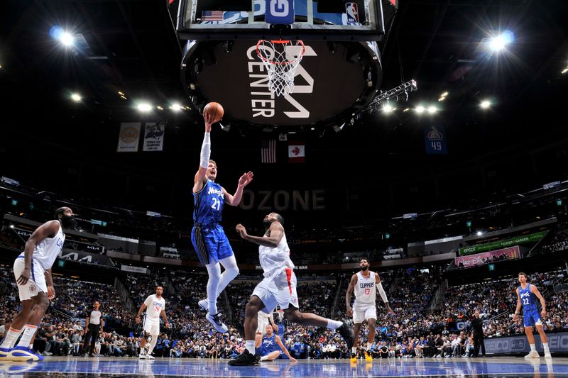 ORLANDO, FL - MARCH 29: Moritz Wagner #21 of the Orlando Magic drives to the basket during the game against the LA Clippers on March 29, 2024 at the Kia Center in Orlando, Florida. NOTE TO USER: User expressly acknowledges and agrees that, by downloading and or using this photograph, User is consenting to the terms and conditions of the Getty Images License Agreement. Mandatory Copyright Notice: Copyright 2024 NBAE (Photo by Fernando Medina/NBAE via Getty Images)