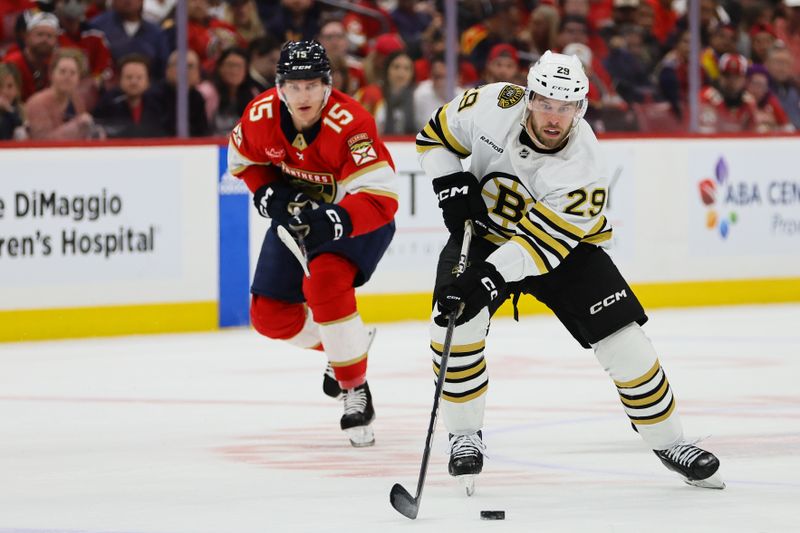 May 6, 2024; Sunrise, Florida, USA; Boston Bruins defenseman Parker Wotherspoon (29) moves the puck past Florida Panthers center Anton Lundell (15) during the first period in game one of the second round of the 2024 Stanley Cup Playoffs at Amerant Bank Arena. Mandatory Credit: Sam Navarro-USA TODAY Sports