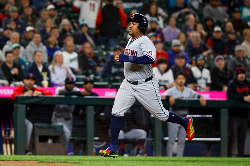 Apr 2, 2024; Seattle, Washington, USA; Cleveland Guardians third baseman Jose Ramirez (11) scores a run on a sacrifice fly by center fielder Tyler Freeman (2, not pictured) against the Seattle Mariners during the seventh inning at T-Mobile Park. Mandatory Credit: Joe Nicholson-USA TODAY Sports