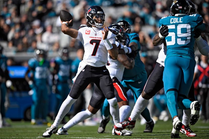 Houston Texans quarterback C.J. Stroud (7) throws a pass as he is pressured by Jacksonville Jaguars defensive end Myles Cole (59) during the first half of an NFL football game Sunday, Dec. 1, 2024, in Jacksonville, Fla. (AP Photo/Phelan M. Ebenhack)