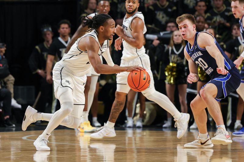 Jan 13, 2024; Orlando, Florida, USA; UCF Knights guard Shemarri Allen (2) drives to the basket against Brigham Young Cougars guard Dallin Hall (30) during the first period at Addition Financial Arena. Mandatory Credit: Mike Watters-USA TODAY Sports