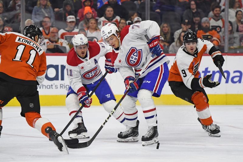 Oct 27, 2024; Philadelphia, Pennsylvania, USA; Montreal Canadiens center Jake Evans (71) battles for the puck with Philadelphia Flyers right wing Travis Konecny (11) and defenseman Jamie Drysdale (9) during the second period at Wells Fargo Center. Mandatory Credit: Eric Hartline-Imagn Images