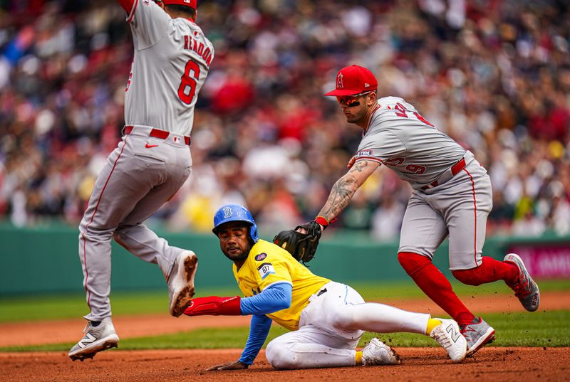 Apr 14, 2024; Boston, Massachusetts, USA; Boston Red Sox second baseman Pablo Reyes (19) is tagged out by Los Angeles Angels shortstop Zach Neto (9) in the fifth inning at Fenway Park. Mandatory Credit: David Butler II-USA TODAY Sports