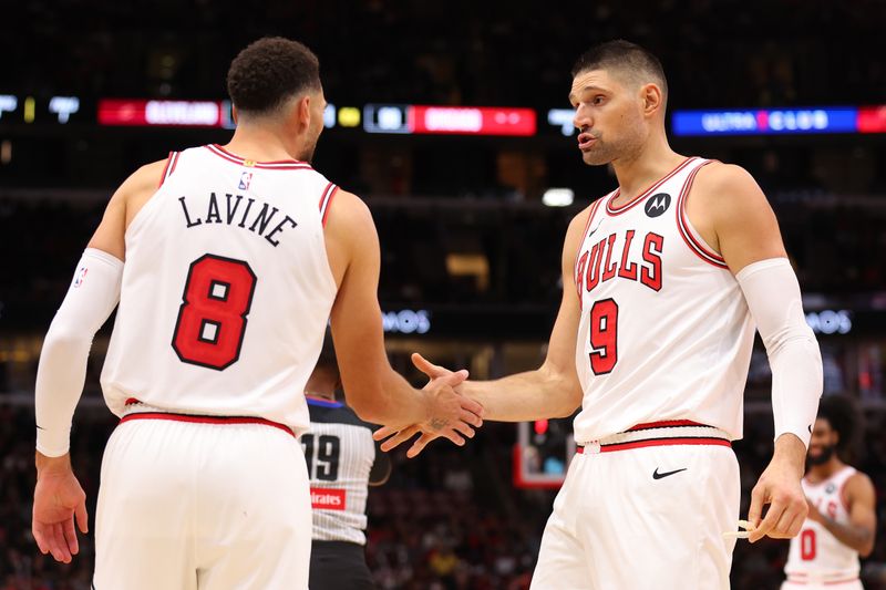 CHICAGO, ILLINOIS - OCTOBER 18: Zach LaVine #8 and Nikola Vucevic #9 of the Chicago Bulls high five against the Cleveland Cavaliers during the second half of a preseason game at the United Center on October 18, 2024 in Chicago, Illinois. NOTE TO USER: User expressly acknowledges and agrees that, by downloading and or using this photograph, User is consenting to the terms and conditions of the Getty Images License Agreement.  (Photo by Michael Reaves/Getty Images)