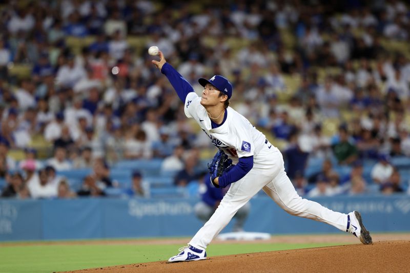 Sep 10, 2024; Los Angeles, California, USA;  Los Angeles Dodgers starting pitcher Yoshinobu Yamamoto (18) throws the first pitch of the game during the first inning against the Chicago Cubs at Dodger Stadium. Mandatory Credit: Kiyoshi Mio-Imagn Images