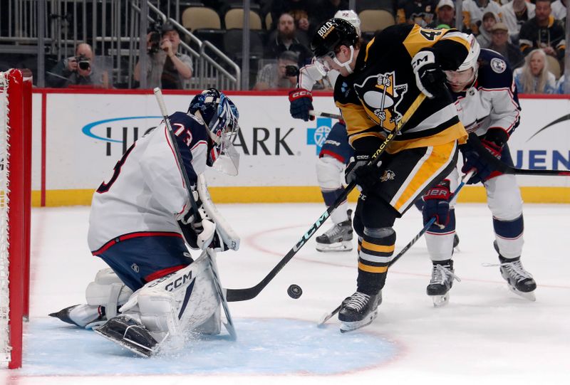 Mar 5, 2024; Pittsburgh, Pennsylvania, USA; Columbus Blue Jackets goaltender Jet Greaves (73) makes a save against Pittsburgh Penguins right wing Valtteri Puustinen (48) during the first period at PPG Paints Arena. Mandatory Credit: Charles LeClaire-USA TODAY Sports