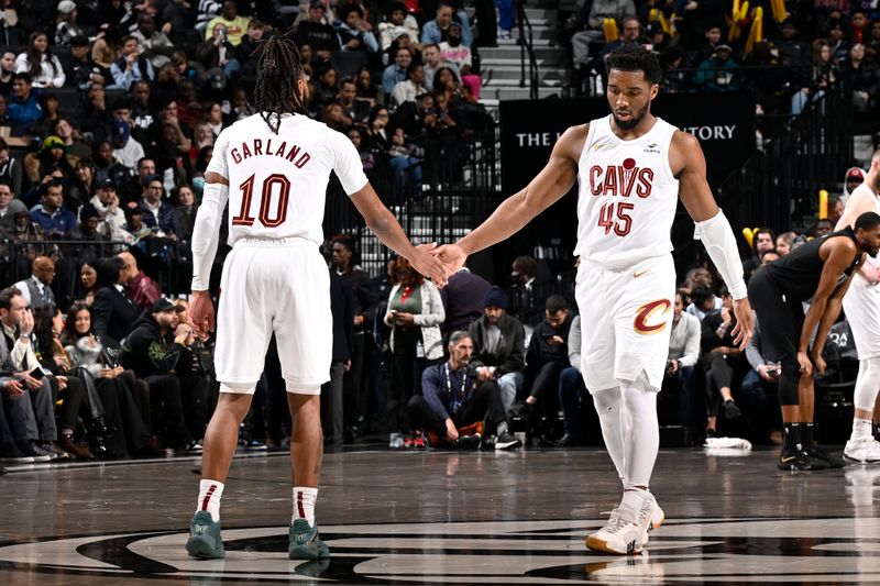 BROOKLYN, NY - FEBRUARY 8: Darius Garland #10 high fives Donovan Mitchell #45 of the Cleveland Cavaliers during the game against the Brooklyn Nets on February 8, 2024 at the Barclays Center in Brooklyn, New York. NOTE TO USER: User expressly acknowledges and agrees that, by downloading and/or using this Photograph, user is consenting to the terms and conditions of the Getty Images License Agreement. Mandatory Copyright Notice: Copyright 2024 NBAE (Photo by David Dow/NBAE via Getty Images)