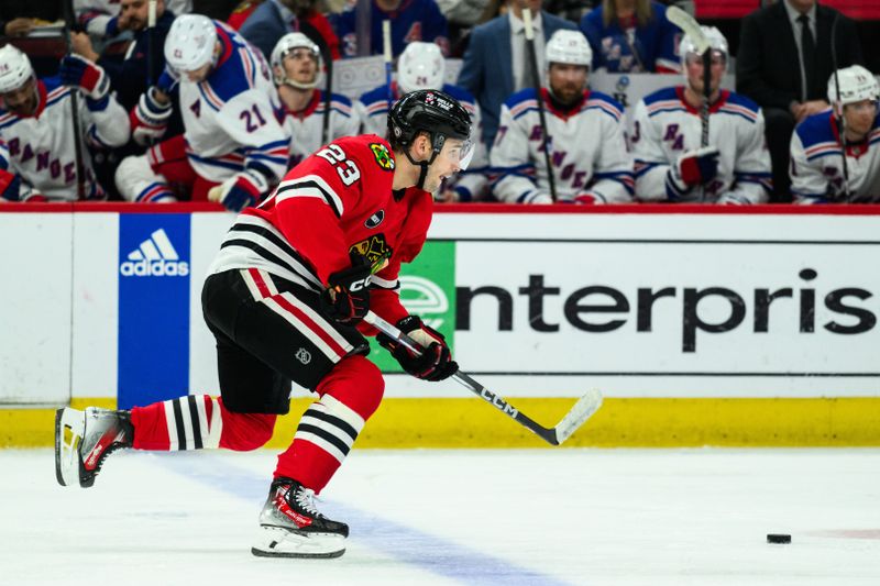 Feb 9, 2024; Chicago, Illinois, USA; Chicago Blackhawks center Philipp Kurashev (23) skates with the puck against the New York Rangers during the second period at the United Center. Mandatory Credit: Daniel Bartel-USA TODAY Sports