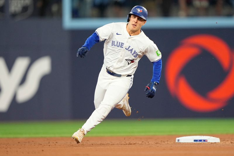 Aug 20, 2024; Toronto, Ontario, CAN; Toronto Blue Jays center fielder Daulton Varsho (25) runs to third base on his triple against the Cincinnati Reds during the first inning at Rogers Centre. Mandatory Credit: John E. Sokolowski-USA TODAY Sports