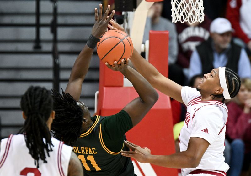 Dec 22, 2025; Bloomington, Indiana, USA; Indiana Hoosiers forward Sam Alexis (4) defends against Siena Saints forward Francis Folefac (11) during the first half at Simon Skjodt Assembly Hall. Mandatory Credit: Robert Goddin-Imagn Images