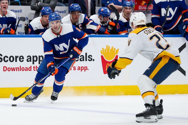 Apr 6, 2024; Elmont, New York, USA; New York Islanders center Kyle Palmieri (21) skates the puck into the zone against Nashville Predators defenseman Spencer Stastney (24) during the second period at UBS Arena. Mandatory Credit: Tom Horak-USA TODAY Sports