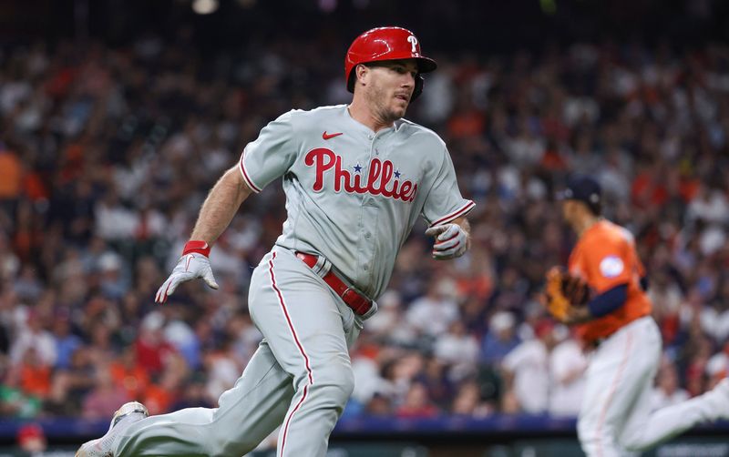 Apr 30, 2023; Houston, Texas, USA; Philadelphia Phillies catcher J.T. Realmuto (10) runs to first base on a play during the eighth inning against the Houston Astros at Minute Maid Park. Mandatory Credit: Troy Taormina-USA TODAY Sports