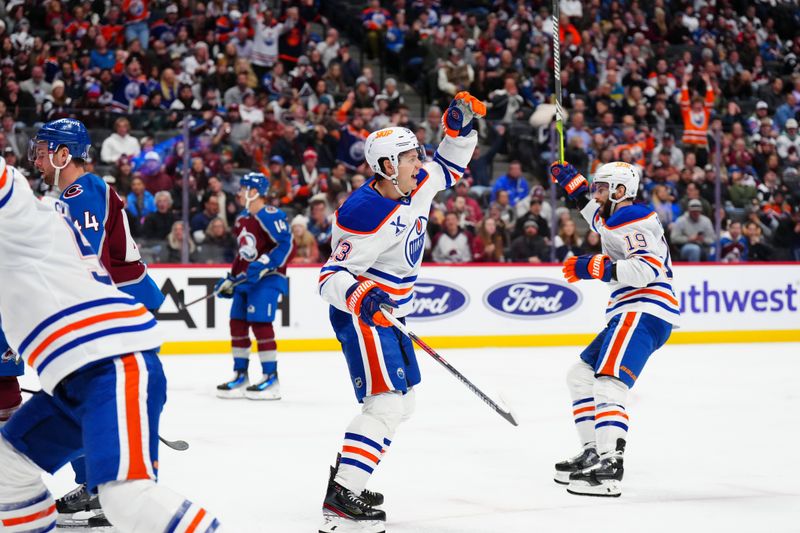 Nov 30, 2024; Denver, Colorado, USA; Edmonton Oilers center Mattias Janmark (13) and center Adam Henrique (19) celebrates a goal scored in the third period against the Colorado Avalanche at Ball Arena. Mandatory Credit: Ron Chenoy-Imagn Images