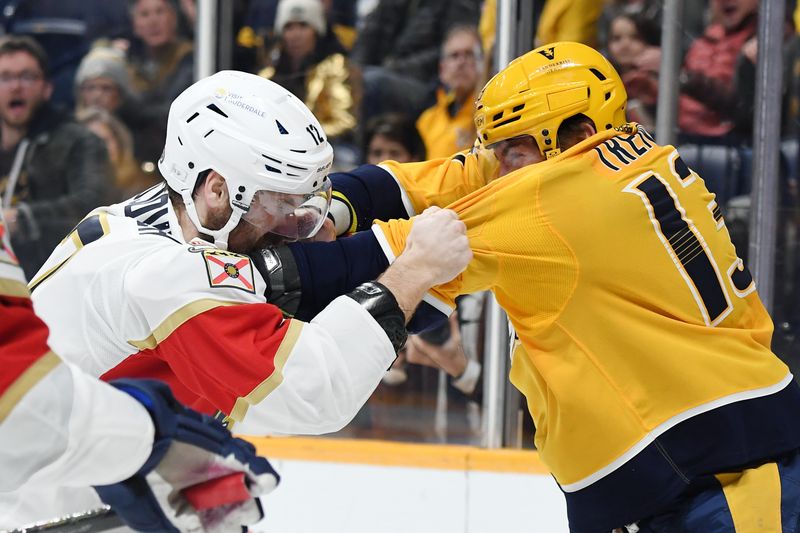 Jan 22, 2024; Nashville, Tennessee, USA; Nashville Predators center Yakov Trenin (13) and Florida Panthers left wing Jonah Gadjovich (12) fight during the second period at Bridgestone Arena. Mandatory Credit: Christopher Hanewinckel-USA TODAY Sports