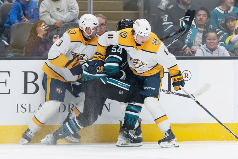 Feb 24, 2024; San Jose, California, USA; Nashville Predators defenseman Jeremy Lauzon (3) and center Cody Glass (8) pin San Jose Sharks right wing Givani Smith (54) against the wall during the second period at SAP Center at San Jose. Mandatory Credit: Stan Szeto-USA TODAY Sports