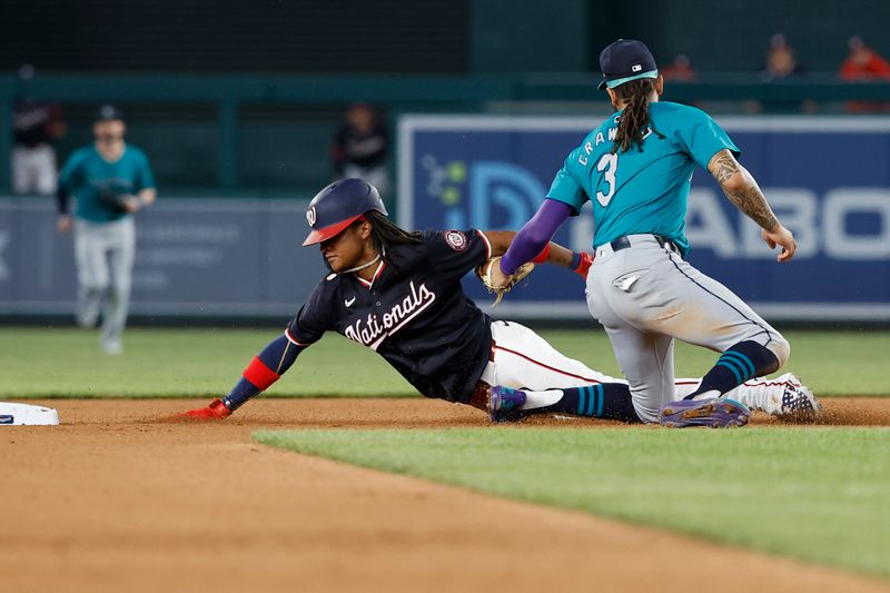 May 24, 2024; Washington, District of Columbia, USA; Washington Nationals shortstop CJ Abrams (5) is tagged out by Seattle Mariners shortstop J.P. Crawford (3) attempting to steal second base during the seventh inning at Nationals Park. Mandatory Credit: Geoff Burke-USA TODAY Sports