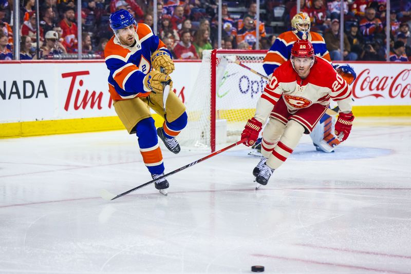 Jan 20, 2024; Calgary, Alberta, CAN; Edmonton Oilers defenseman Evan Bouchard (2) passes the puck in front of Calgary Flames center Blake Coleman (20) during the second period at Scotiabank Saddledome. Mandatory Credit: Sergei Belski-USA TODAY Sports