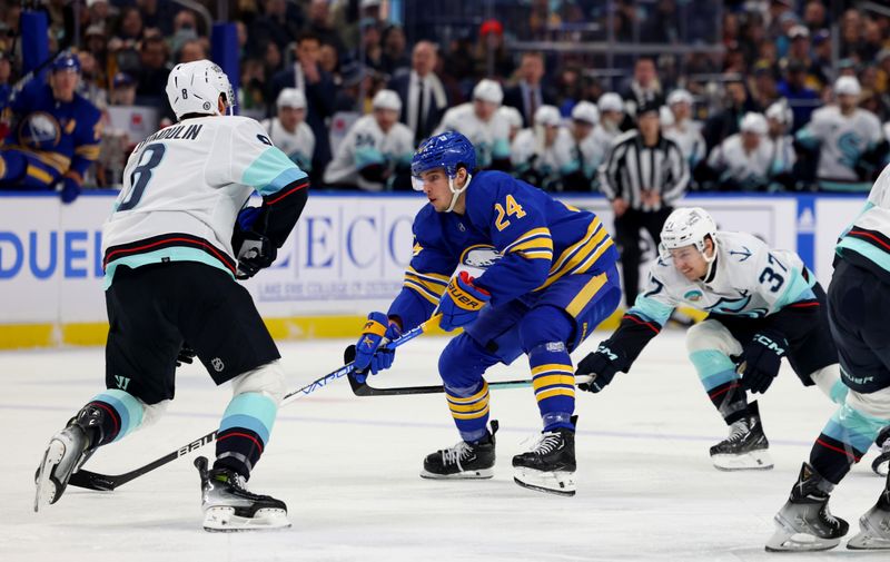 Jan 9, 2024; Buffalo, New York, USA;  Buffalo Sabres center Dylan Cozens (24) skates with the puck as Seattle Kraken center Yanni Gourde (37) defends during the second period at KeyBank Center. Mandatory Credit: Timothy T. Ludwig-USA TODAY Sports