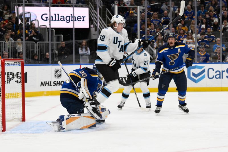 Nov 7, 2024; St. Louis, Missouri, USA; Utah Hockey Club center Logan Cooley (92) attempts to screen St. Louis Blues goaltender Joel Hofer (30) during the first period at Enterprise Center. Mandatory Credit: Jeff Le-Imagn Images