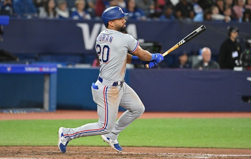 Sep 14, 2023; Toronto, Ontario, CAN;   Texas Rangers left fielder Ezequiel Duran (20) hits a double against the Toronto Blue Jays in the eighth inning at Rogers Centre. Mandatory Credit: Dan Hamilton-USA TODAY Sports