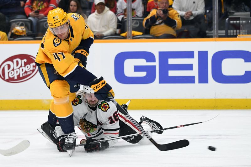 Jan 2, 2024; Nashville, Tennessee, USA; Nashville Predators right wing Michael McCarron (47) shoots the puck as he is defended by Chicago Blackhawks center Jason Dickinson (16) during the first period at Bridgestone Arena. Mandatory Credit: Christopher Hanewinckel-USA TODAY Sports