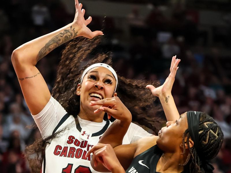 Jan 28, 2024; Columbia, South Carolina, USA; South Carolina Gamecocks center Kamilla Cardoso (10) grabs a rebound over Vanderbilt Commodores guard Jordyn Oliver (11) in the first half at Colonial Life Arena. Mandatory Credit: Jeff Blake-USA TODAY Sports