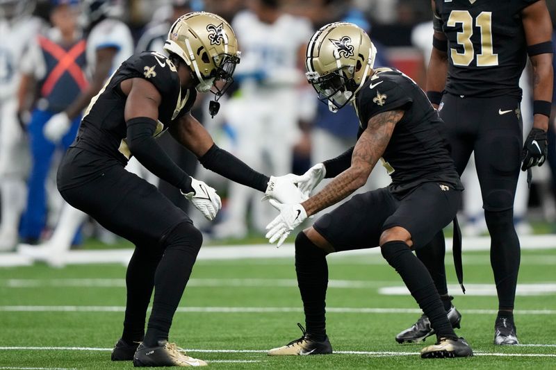 New Orleans Saints cornerback Paulson Adebo, left, and cornerback Alontae Taylor, right, celebrate a defensive stop against the Tennessee Titans in the first half of an NFL football game in New Orleans, Sunday, Sept. 10, 2023. (AP Photo/Gerald Herbert)