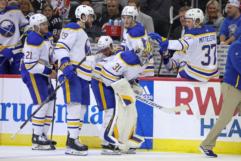 Oct 27, 2023; Newark, New Jersey, USA; Buffalo Sabres goaltender Eric Comrie (31) skates off the ice with teammates after an injury during the second period against the New Jersey Devils at Prudential Center. Mandatory Credit: Vincent Carchietta-USA TODAY Sports