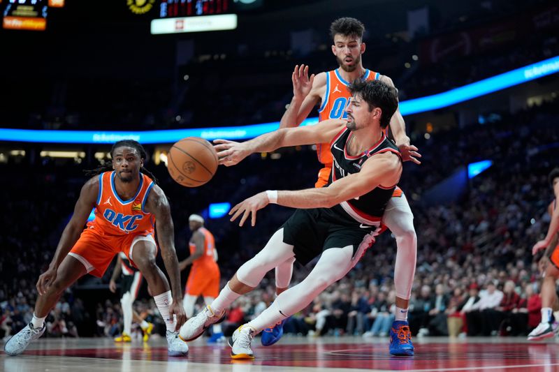 PORTLAND, OREGON - NOVEMBER 01: Deni Avdija #8 of the Portland Trail Blazers passes the ball as he falls while being defended by Chet Holmgren #7 of the Oklahoma City Thunder  during the second half at Moda Center on November 01, 2024 in Portland, Oregon. NOTE TO USER: User expressly acknowledges and agrees that, by downloading and or using this photograph, User is consenting to the terms and conditions of the Getty Images License Agreement. (Photo by Soobum Im/Getty Images)