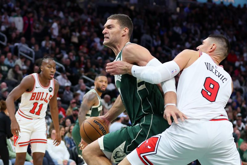 MILWAUKEE, WISCONSIN - OCTOBER 25: Brook Lopez #11 of the Milwaukee Bucks drives around Nikola Vucevic #9 of the Chicago Bulls during the second half of a game at Fiserv Forum on October 25, 2024 in Milwaukee, Wisconsin. NOTE TO USER: User expressly acknowledges and agrees that, by downloading and or using this photograph, User is consenting to the terms and conditions of the Getty Images License Agreement. (Photo by Stacy Revere/Getty Images)