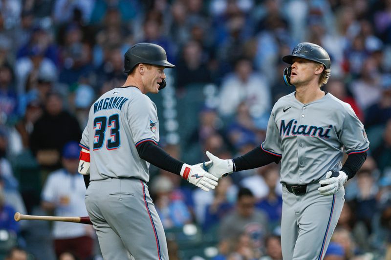 May 14, 2025; Chicago, Illinois, USA; Miami Marlins center fielder Kyle Stowers (28) celebrates with left fielder Eric Wagaman (33) after hitting a solo home run against the Chicago Cubs during the fourth inning at Wrigley Field. Mandatory Credit: Kamil Krzaczynski-Imagn Images