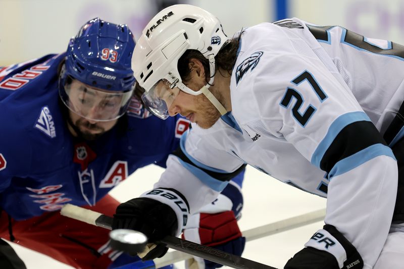 Jan 5, 2026; New York, New York, USA; Utah Mammoth center Barrett Hayton (27) plays the puck off a face off against New York Rangers center Mika Zibanejad (93) during the second period at Madison Square Garden. Mandatory Credit: Brad Penner-Imagn Images