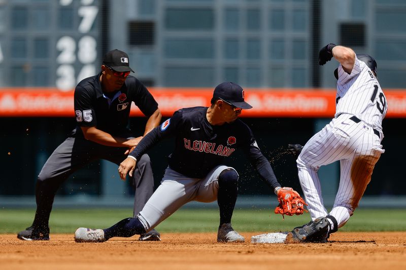 May 27, 2024; Denver, Colorado, USA; Colorado Rockies right fielder Charlie Blackmon (19) slides safely into second against Cleveland Guardians second baseman Andres Gimenez (0) as umpire Jeremie Rehak (35) looks on in the first inning at Coors Field. Mandatory Credit: Isaiah J. Downing-USA TODAY Sports