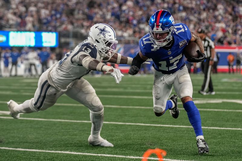 New York Giants wide receiver Wan'Dale Robinson (17) carries the ball against Dallas Cowboys linebacker DeMarvion Overshown (13) during the third quarter of an NFL football game, Thursday, Sept. 26, 2024, in East Rutherford, N.J. (AP Photo/Bryan Woolston)