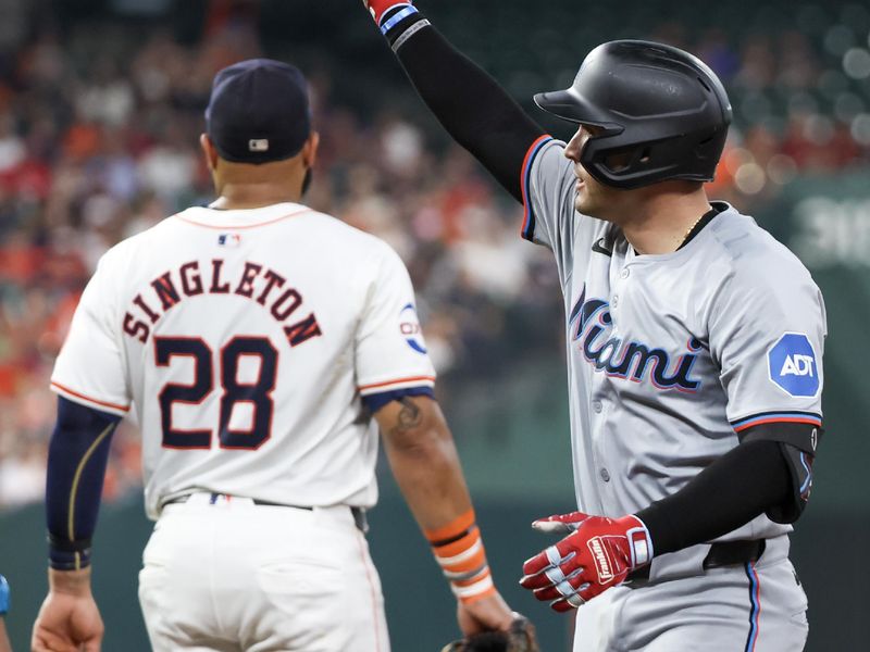 Jul 11, 2024; Houston, Texas, USA; Miami Marlins catcher Nick Fortes (4) reacts to hitting a single against the Houston Astros and first baseman Jon Singleton (28) in the second inning at Minute Maid Park. Mandatory Credit: Thomas Shea-USA TODAY Sports