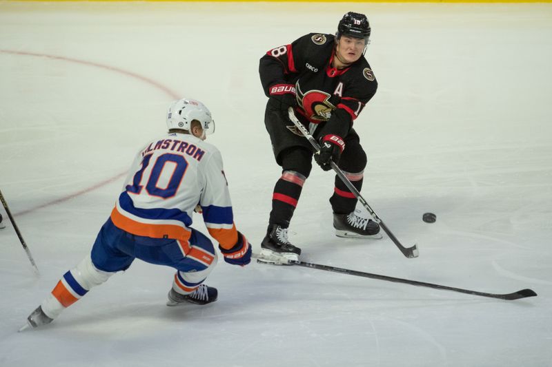 Nov 24 2023; Ottawa, Ontario, CAN; Ottawa Senators center Tim Stutzle (18) shoots the puck past New York Islanders right wing Simon Holmstrom (10) in the third period at the Canadian Tire Centre. Mandatory Credit: Marc DesRosiers-USA TODAY Sports