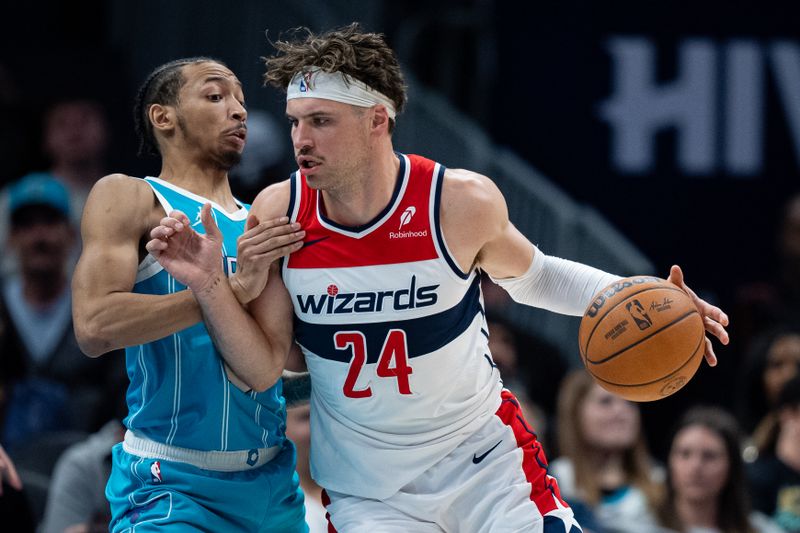 CHARLOTTE, NORTH CAROLINA - FEBRUARY 03: Nick Smith Jr. #8 of the Charlotte Hornets guards Corey Kispert #24 of the Washington Wizards in the second quarter during their game at Spectrum Center on February 03, 2025 in Charlotte, North Carolina. NOTE TO USER: User expressly acknowledges and agrees that, by downloading and or using this photograph, User is consenting to the terms and conditions of the Getty Images License Agreement. (Photo by Jacob Kupferman/Getty Images)