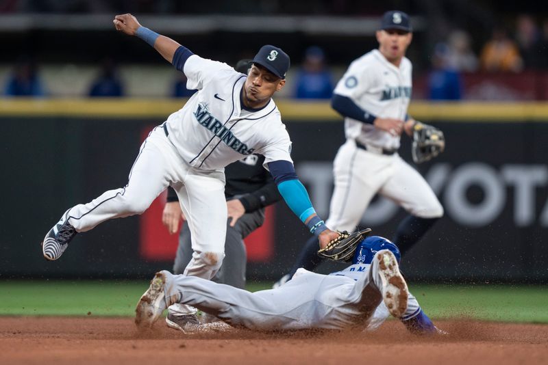 May 13, 2024; Seattle, Washington, USA; Seattle Mariners second baseman Jorge Polanco (7) tags out Kansas City Royals centerfielder Dairon Blanco (44) attempting to steal second base during the fifth inning at T-Mobile Park. Mandatory Credit: Stephen Brashear-USA TODAY Sports